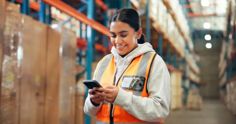 A warehouse associate opening her CultureMonkey survey on her phone